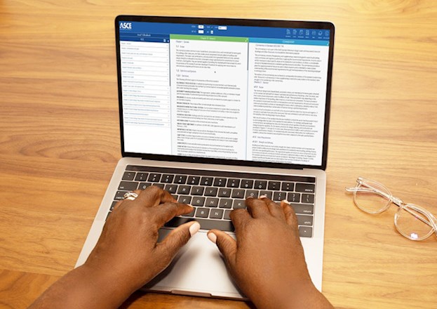 Hands typing on a laptop displaying the ASCE 7 online tool